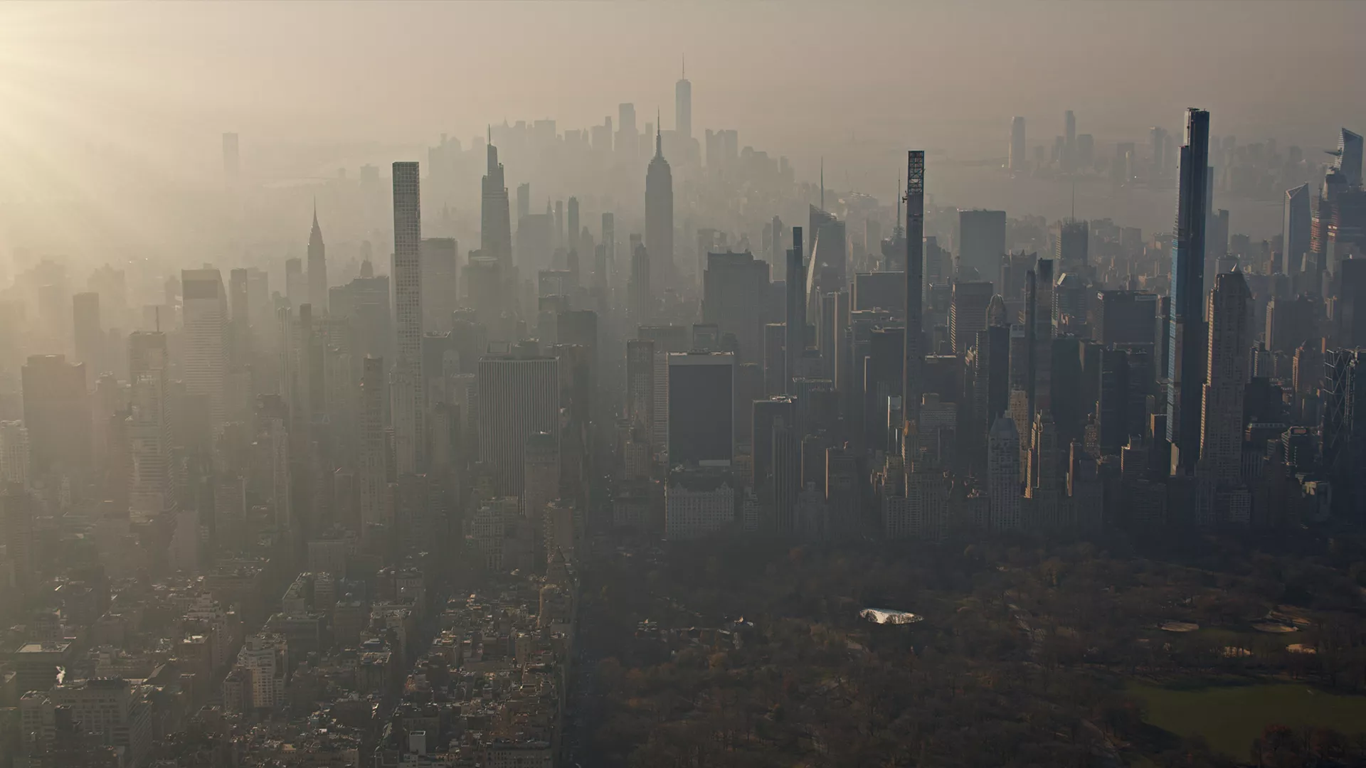 image of a city skyline with a lot of smog and pollution making it hard to see.